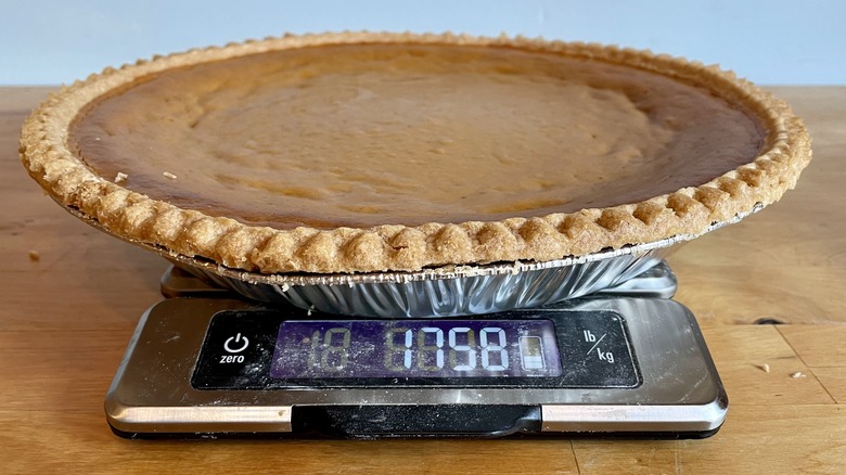 Large pumpkin pie on kitchen scale