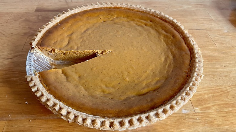 Pumpkin pie with a slice taken out