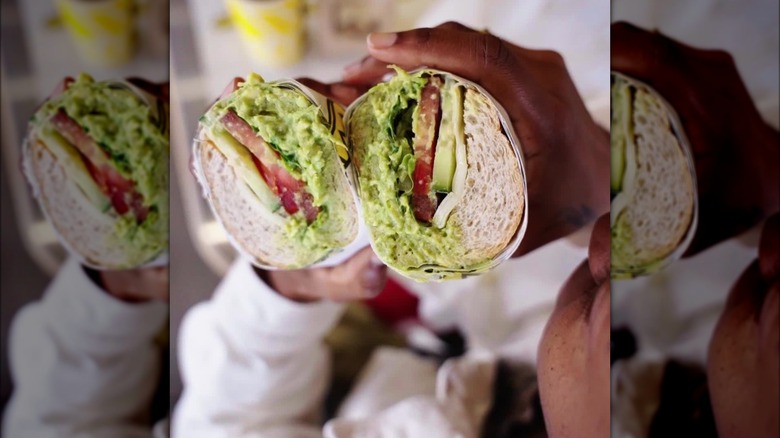 hand holding which wich sub