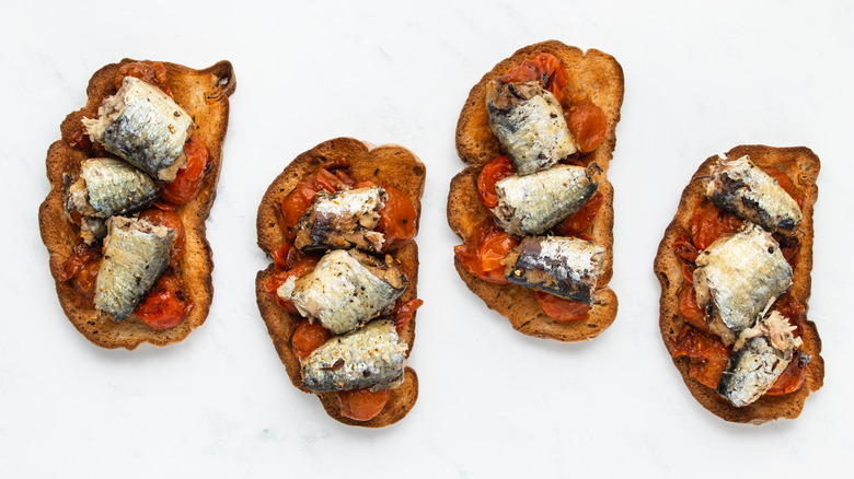 Four sardine and tomato toast slices