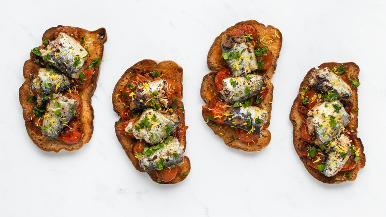 Four sardine and tomato toast slices