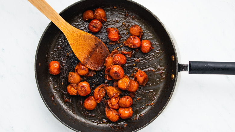 Cherry tomatoes frying in pan