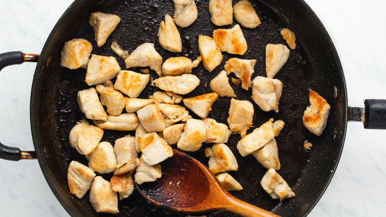diced chicken cooking in skillet
