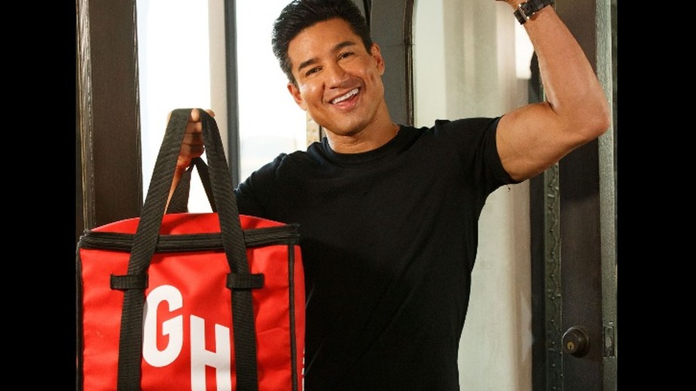 Mario Lopez with a Grubhub bag slung over his shoulder