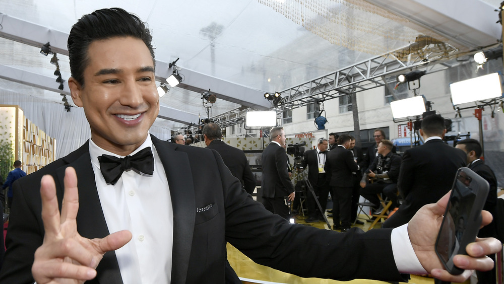 Mario Lopez throwing a peace sign and taking a selfie