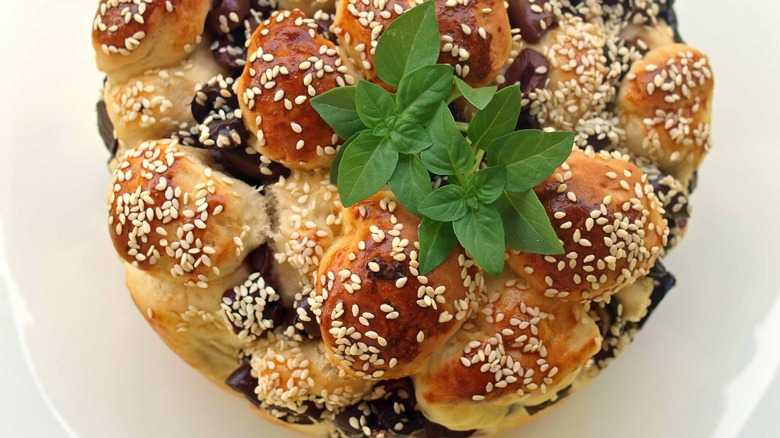 Black olive money bread with sesame sees and fresh herbs