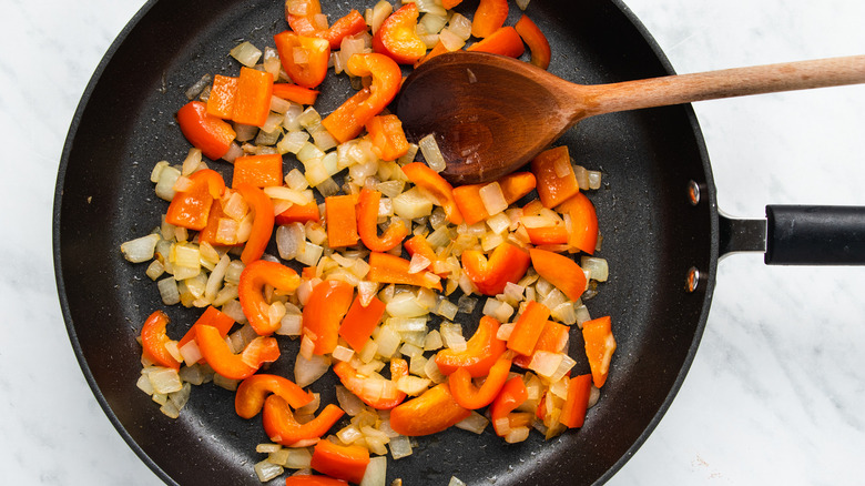 onion and peppers in pan 