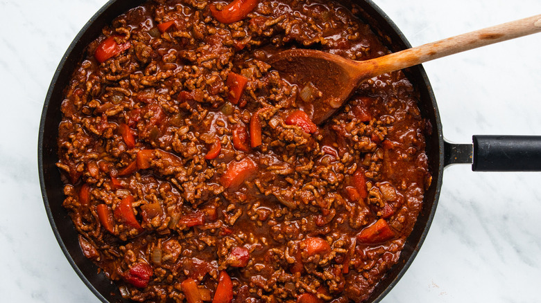 chili in pan with spices 