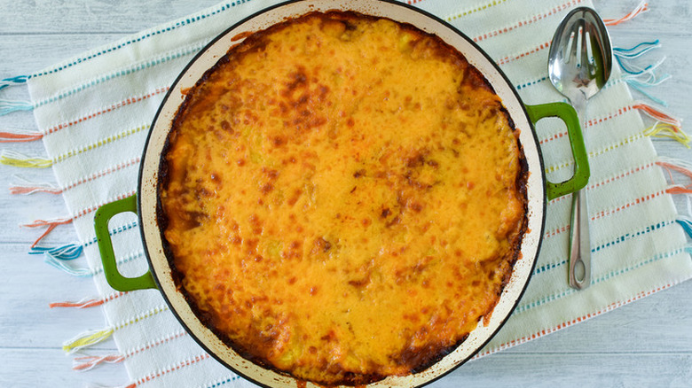 Round casserole with layer of baked, melted cheese. 