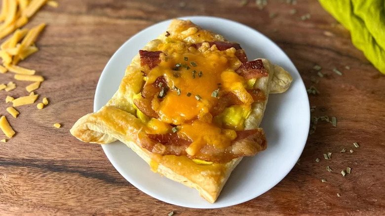 Puff pastry square with bacon and cheese.