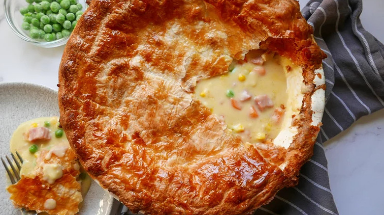 Large browned pie with ham and veggie filling. 