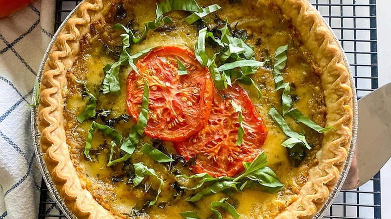 Quiche-type pie topped with tomatoes and basil.