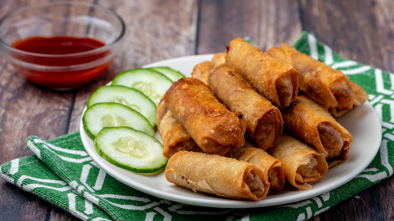 Filipino Lumpia on a serving platter with dipping sauce