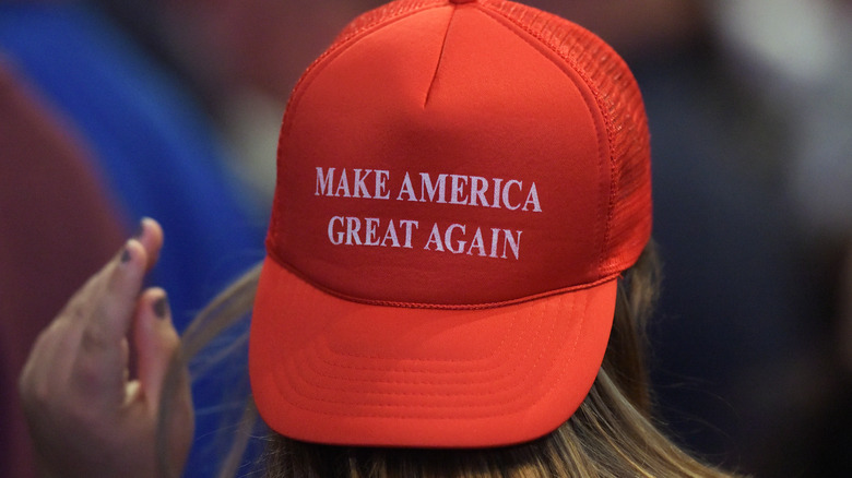 Woman in MAGA hat