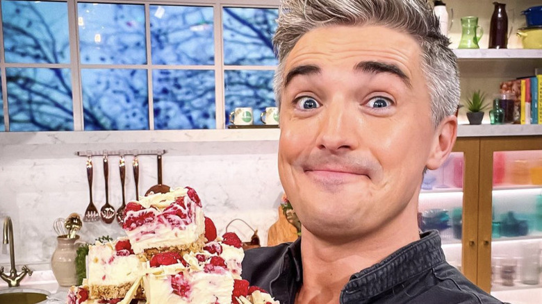 Donal Skehan grins with a plate of raspberry bars