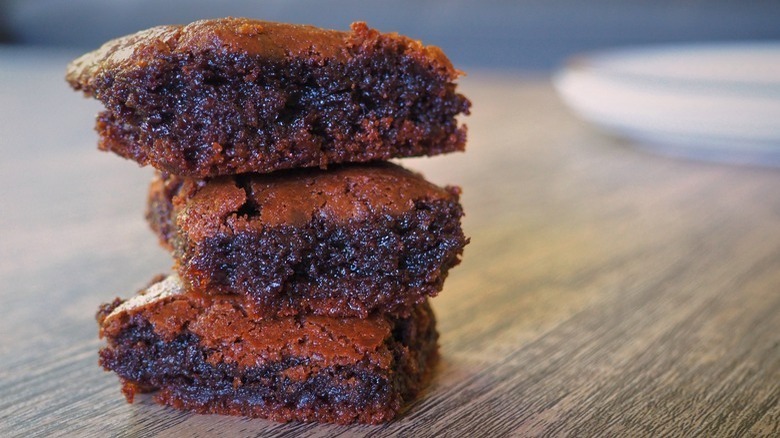 three brownies piled on table