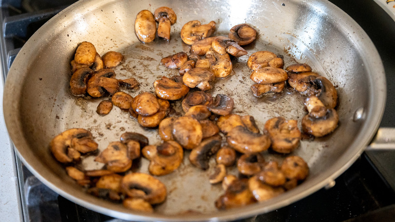 sauteeing mushrooms in pan