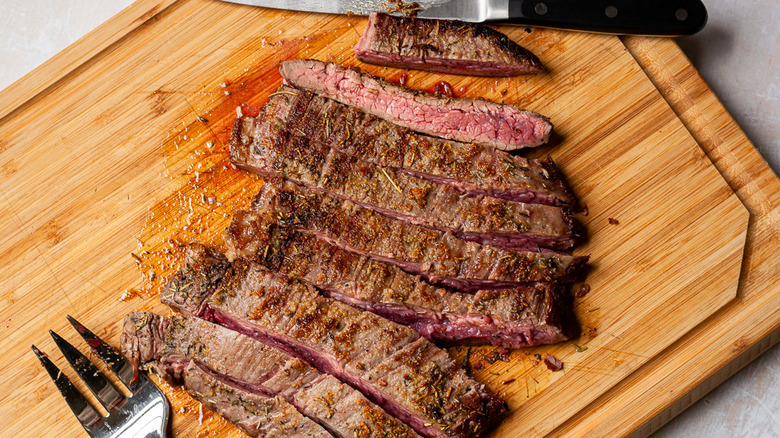 sliced steak on cutting board