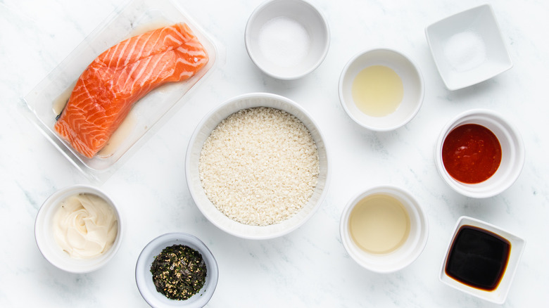 Salmon, rice, and seasonings in bowls