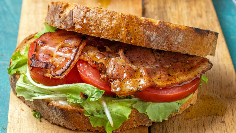 Toasted BLT sandwich on wooden board