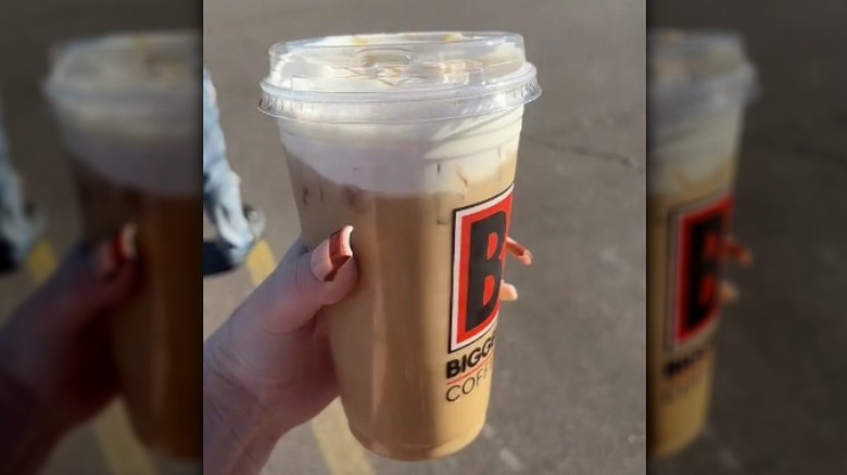 hand holding Biggby cup