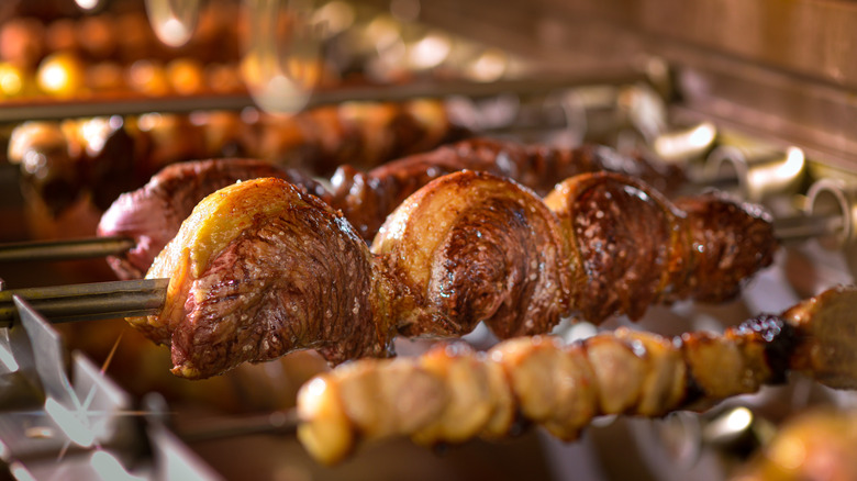 Different grilled meat cuts on skewers