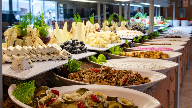 Salad bar with cheese plate and cold dishes