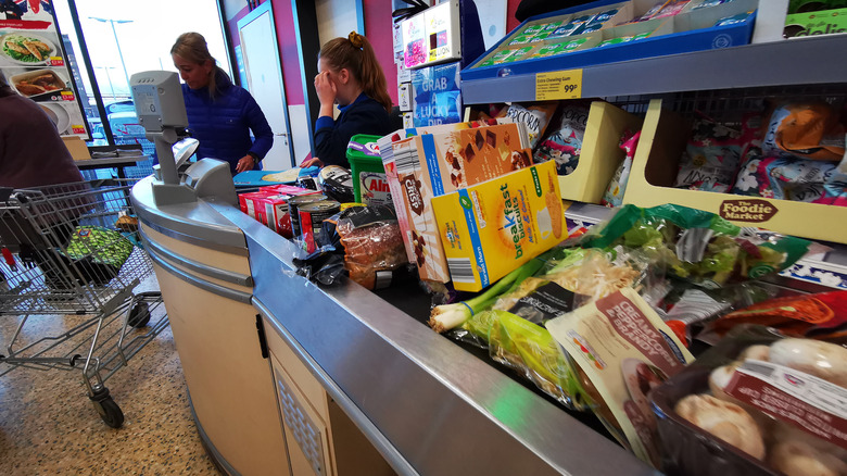 woman standing at Aldi checkout