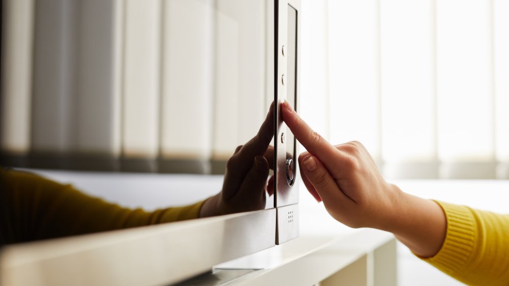 person using microwave for cinnabons