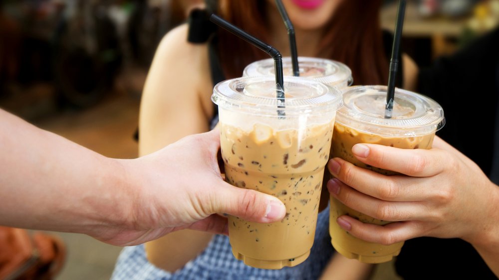 friends holding iced coffees