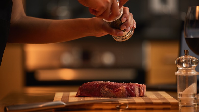 Seasoning steak on counter