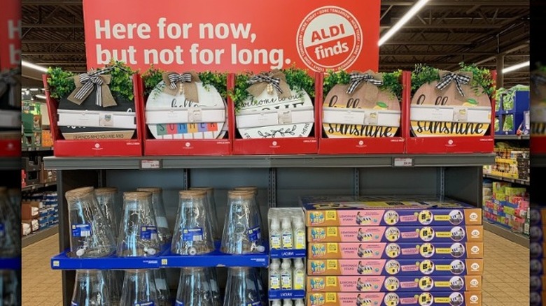 Aldi sign saying "here for now, but not for long"