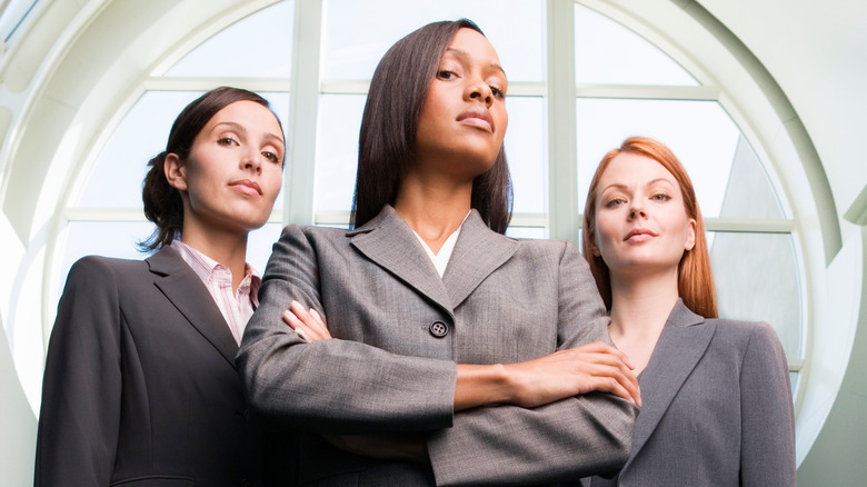 three women in gray suits