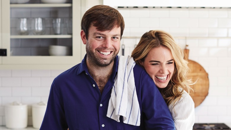 Serena Wolf posing with husband in the kitchen