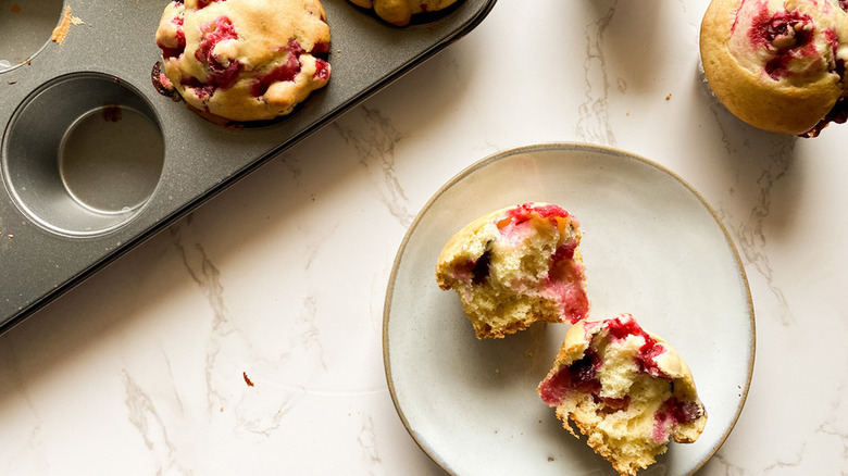 cranberry muffins in a tin and on a plate