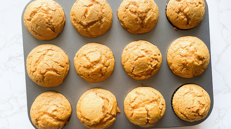 muffin tin full of pumpkin muffins