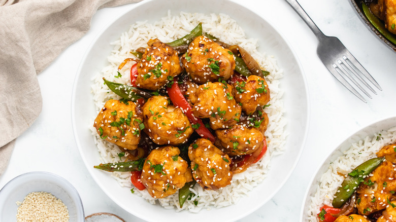 Sesame cauliflower stir fry and rice in bowl