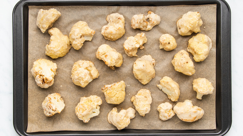 Baked cauliflower florets on baking sheet