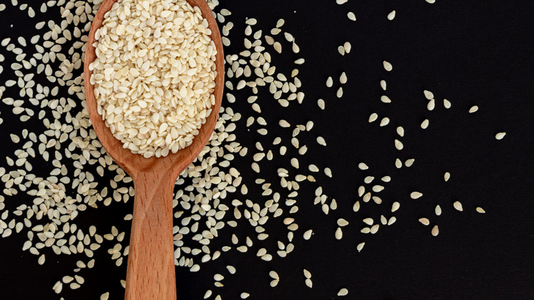 Sesame seeds in wooden spoon