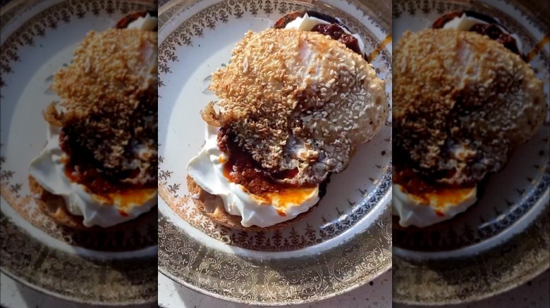 Fried egg covered in sesame seeds on toast