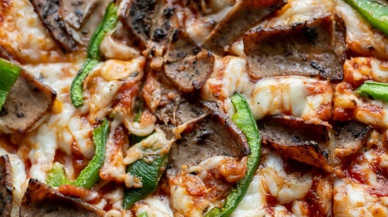 close up of cheese pizza with steak and bell peppers