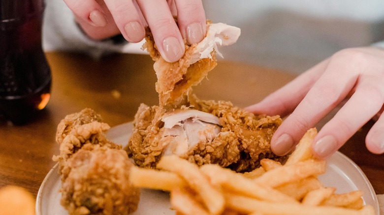 Person eating KFC chicken 