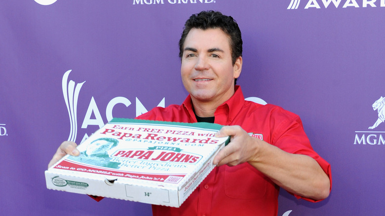 John Schnatter with Papa Johns pizza box