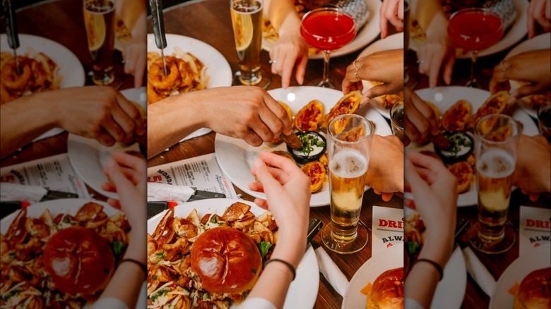 Hands reach for appetizers at TGI Fridays