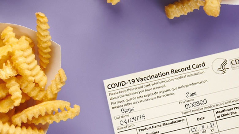 Crinkle French fries next to vaccination card