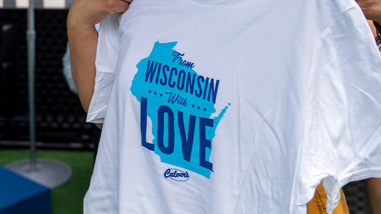 woman holding Culver's t-shirt saying From Wisconsin With Love