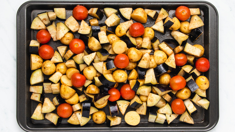 Potatoes and veg on baking sheet