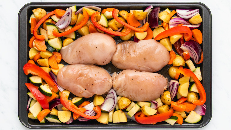 Chicken and veg on baking sheet