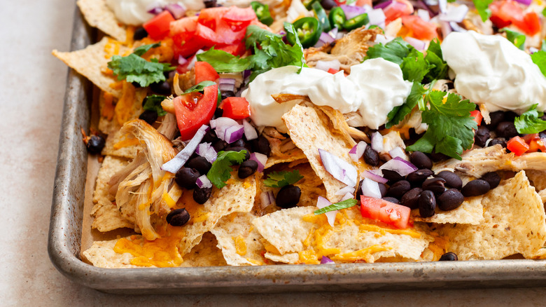 loaded chicken nachos on pan