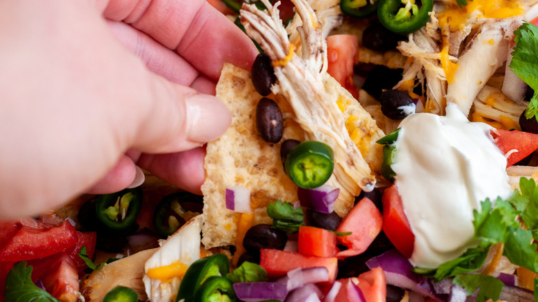 hand grabbing a nacho